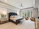 Spacious main bedroom with a tray ceiling, sitting area, and large windows letting in natural light at 8912 Heydon Hall Cir, Charlotte, NC 28210