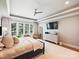 Comfortable bedroom with a ceiling fan, a dresser, and large windows for natural light at 8912 Heydon Hall Cir, Charlotte, NC 28210
