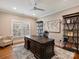 Office space features hardwood floors, large desk, world map art, and natural light at 8912 Heydon Hall Cir, Charlotte, NC 28210