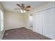 Bedroom showing a ceiling fan, window, carpet, closet and doorway to the bathroom for convenient access at 907 Bethpage Rd, Kannapolis, NC 28081
