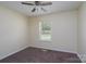 Comfortable bedroom with plush carpet, a ceiling fan, and a bright window at 907 Bethpage Rd, Kannapolis, NC 28081
