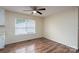 Bright dining room offers a ceiling fan, wood floor, and large window for natural light at 907 Bethpage Rd, Kannapolis, NC 28081