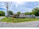 Side street view of a home featuring a fenced yard, a porch, and mature trees at 907 Bethpage Rd, Kannapolis, NC 28081