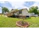Landscaped front yard showcases vibrant flower beds and a well-maintained lawn, enhancing curb appeal at 907 Bethpage Rd, Kannapolis, NC 28081