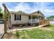 A charming single-story home boasts a manicured lawn, complemented by a ramp and covered carport at 907 Bethpage Rd, Kannapolis, NC 28081