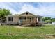 Charming single-story home with a welcoming front porch and ramp, surrounded by a well-maintained lawn at 907 Bethpage Rd, Kannapolis, NC 28081