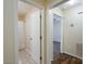 Hallway view with doorways to a bathroom with shower and a bedroom with ceiling fan and closet at 907 Bethpage Rd, Kannapolis, NC 28081