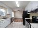 Well-lit kitchen featuring stainless steel appliances, white cabinetry, and a functional layout at 907 Bethpage Rd, Kannapolis, NC 28081