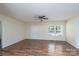 Spacious living room features stylish wood floors, a ceiling fan, and a window for natural light at 907 Bethpage Rd, Kannapolis, NC 28081
