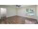 Inviting living room featuring wood floors, a ceiling fan, and a window for ample natural light at 907 Bethpage Rd, Kannapolis, NC 28081