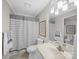 Bathroom with single vanity, tub with shower, and neutral color scheme at 925 Lanier Ln, Monroe, NC 28110