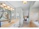 Bathroom with large mirror, vanity with sink, tub and shower combo, and tile flooring at 925 Lanier Ln, Monroe, NC 28110