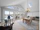 Open dining area with skylight, tile flooring, and access to a deck overlooking a lake at 925 Lanier Ln, Monroe, NC 28110