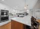 Modern kitchen with white cabinets, stainless steel appliances, a spacious island with seating, and hardwood floors at 925 Lanier Ln, Monroe, NC 28110
