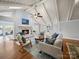 Inviting living room with a fireplace, vaulted ceilings, skylights, hardwood floors, and access to an outdoor deck at 925 Lanier Ln, Monroe, NC 28110