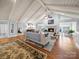 Open-concept living room with hardwood floors, vaulted ceilings, a cozy fireplace, and seamless transitions to other spaces at 925 Lanier Ln, Monroe, NC 28110