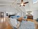 Spacious living room with vaulted ceilings, hardwood floors, neutral decor, and an open layout to the kitchen at 925 Lanier Ln, Monroe, NC 28110