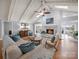 Cozy living room with a fireplace, vaulted ceilings, skylights, hardwood floors, and comfortable seating arrangement at 925 Lanier Ln, Monroe, NC 28110