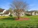 A view of the home's backyard in a suburban neighborhood on a sunny day at 10107 Atkins Ridge Dr, Charlotte, NC 28213