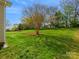 Spacious backyard featuring lush green grass and landscaping at 10107 Atkins Ridge Dr, Charlotte, NC 28213