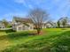 Well-maintained backyard with mature trees, a patio and inviting outdoor space at 10107 Atkins Ridge Dr, Charlotte, NC 28213