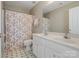 Bright bathroom with double sinks, vanity, and floral print shower curtain at 10107 Atkins Ridge Dr, Charlotte, NC 28213