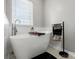Bright bathroom featuring a soaking tub and modern fixtures at 10107 Atkins Ridge Dr, Charlotte, NC 28213