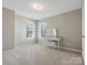 Bright bedroom featuring neutral walls, plush carpet, and a white vanity table with a matching bench at 10107 Atkins Ridge Dr, Charlotte, NC 28213