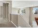 Hallway with neutral paint, carpeted floor, white trim, and natural light from the windows at 10107 Atkins Ridge Dr, Charlotte, NC 28213