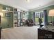 Inviting home office with built-in bookshelves, comfortable seating, and a view of the outdoors at 10107 Atkins Ridge Dr, Charlotte, NC 28213