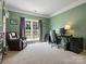 Comfortable home office with a leather chair, modern desk, and views of the backyard at 10107 Atkins Ridge Dr, Charlotte, NC 28213