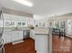 Bright kitchen featuring white cabinets, stainless steel appliances, and a view into the dining area at 10107 Atkins Ridge Dr, Charlotte, NC 28213