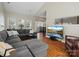 Spacious living room with wood floors, a sectional sofa, and a view into the kitchen and dining room at 10107 Atkins Ridge Dr, Charlotte, NC 28213