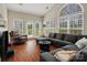 Bright living room with vaulted ceiling, large windows, and a comfortable sectional sofa at 10107 Atkins Ridge Dr, Charlotte, NC 28213