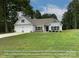 Charming one-story home with white siding, black shutters, and a well-manicured front lawn at 105 Southern Horizon Dr, Statesville, NC 28677