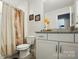 Well-lit bathroom featuring a granite countertop vanity and a shower with a decorative floral curtain at 1066 Chicory Trce, Lake Wylie, SC 29710