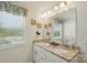 Bright bathroom featuring dual sinks, granite countertops, and a large mirror at 1066 Chicory Trce, Lake Wylie, SC 29710