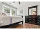 Bedroom featuring hardwood flooring, large windows, and a dark-stained dresser at 1066 Chicory Trce, Lake Wylie, SC 29710