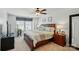 Bright bedroom with a ceiling fan, soft carpet, and a large bed with decorative pillows at 1066 Chicory Trce, Lake Wylie, SC 29710