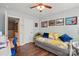 Cozy bedroom with hardwood floors, daybed and pictures on the wall providing a comfortable and personalized space at 1066 Chicory Trce, Lake Wylie, SC 29710