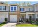 Charming townhome featuring stone accents, a one-car garage, and a beautifully landscaped front yard at 1066 Chicory Trce, Lake Wylie, SC 29710