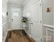 Bright foyer with hardwood floors, white trim, and a glass-paneled front door at 1066 Chicory Trce, Lake Wylie, SC 29710