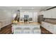Well-lit kitchen with island, stainless steel appliances, and white cabinets with easy access to stairs and dining area at 1066 Chicory Trce, Lake Wylie, SC 29710