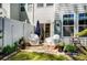 Back patio with pavers, covered chairs, a closed umbrella and landscaped perimeter at 1066 Chicory Trce, Lake Wylie, SC 29710