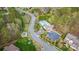 Aerial shot of the community featuring a pool, clubhouse, playground, and winding roads surrounded by trees at 10823 Preservation Park Dr, Charlotte, NC 28214