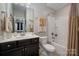 Bathroom features a single vanity, toilet, and shower-tub combination at 10823 Preservation Park Dr, Charlotte, NC 28214