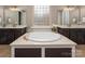 Bright bathroom features a soaking tub, dual vanities, updated fixtures, and a decorative window at 10823 Preservation Park Dr, Charlotte, NC 28214
