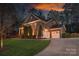 Beautiful brick home with a three-car garage and a well-manicured lawn, offering curb appeal and convenience at 10823 Preservation Park Dr, Charlotte, NC 28214