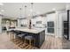 Open kitchen with large island, stainless appliances, and barstool seating at 10823 Preservation Park Dr, Charlotte, NC 28214