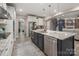 Open kitchen with stainless steel appliances, granite countertops, a large island, and view into the living room at 10823 Preservation Park Dr, Charlotte, NC 28214